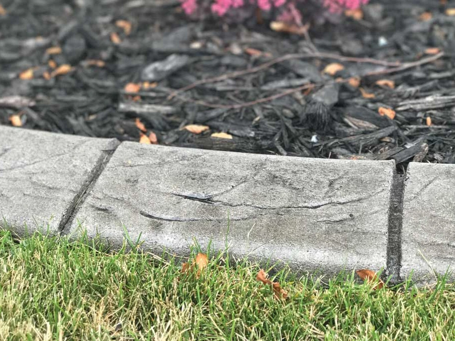 Brick stamp pattern on decorative concrete curbing